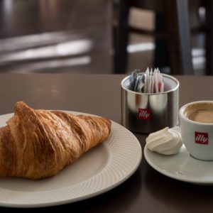 a plate of food and a cup of coffee
