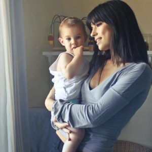 A loving moment between a mother and her child in an indoor setting, fostering connection and warmth.